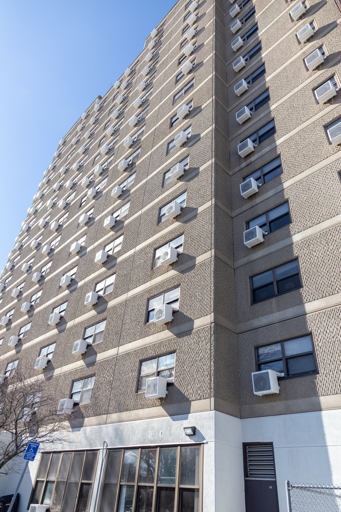 Affordable housing building with window heat pumps installed